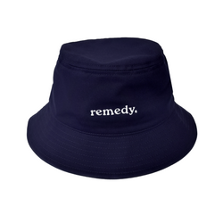 A front view of navy bucket hat with white embroidery branded 'remedy' on the front.